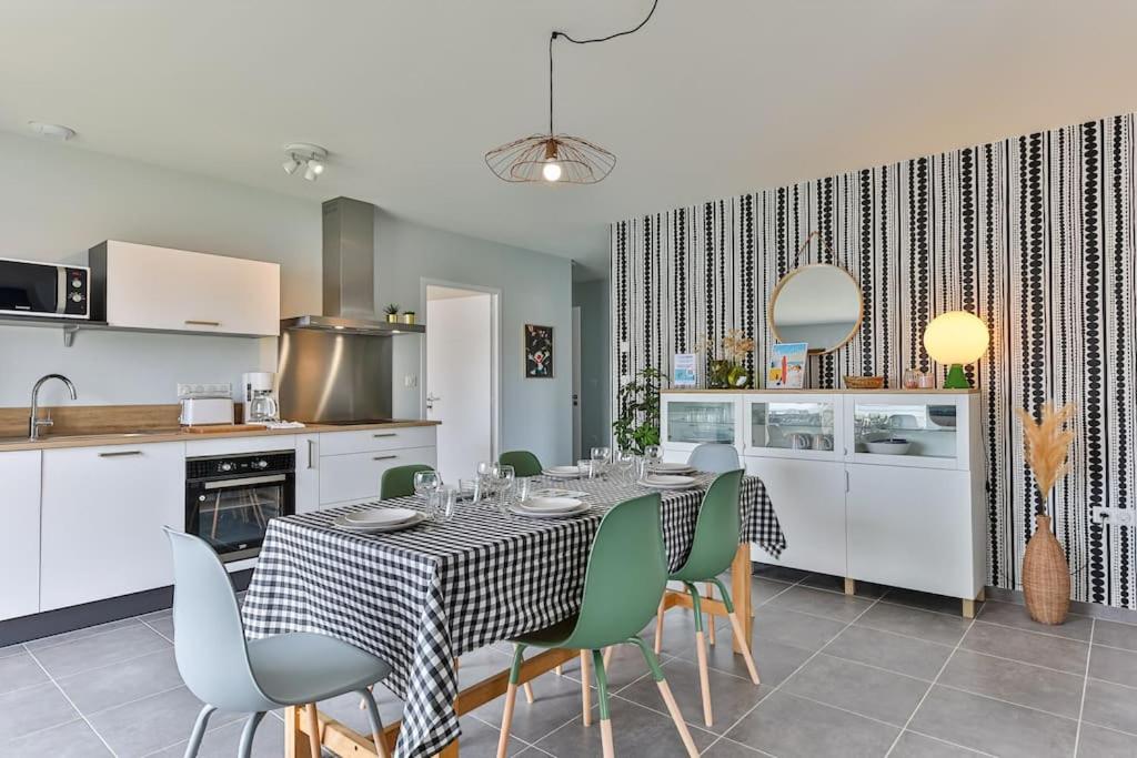 een eetkamer met een tafel en stoelen in een keuken bij Serpentine, à 5mn des plages in Saint-Hilaire-de-Riez