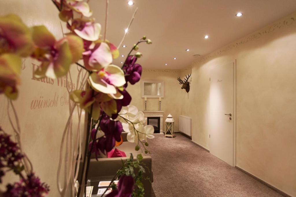 a hallway with a vase with flowers in it at Haus Wilkens in Kerpen