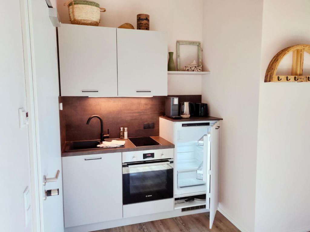 Kuchyň nebo kuchyňský kout v ubytování das herzstück - Schaubrennerei, Hausbrauerei & Apartments
