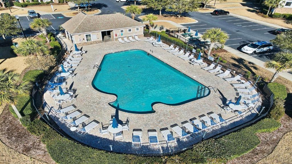 an aerial view of a pool with chairs and a resort at 321 Willow Bend condo in North Myrtle Beach