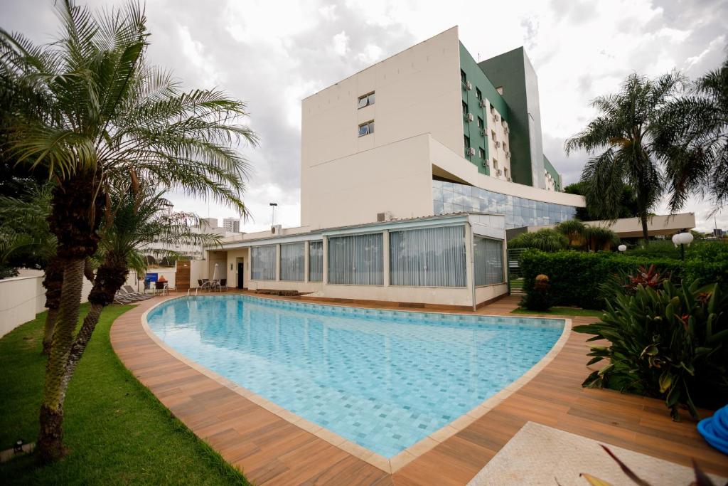 a swimming pool in front of a building at Comfort Suites Londrina in Londrina
