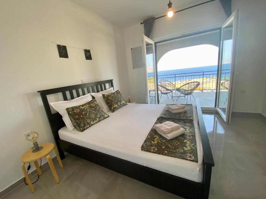 a bedroom with a bed with a view of the ocean at Apartments Dolores in Senj