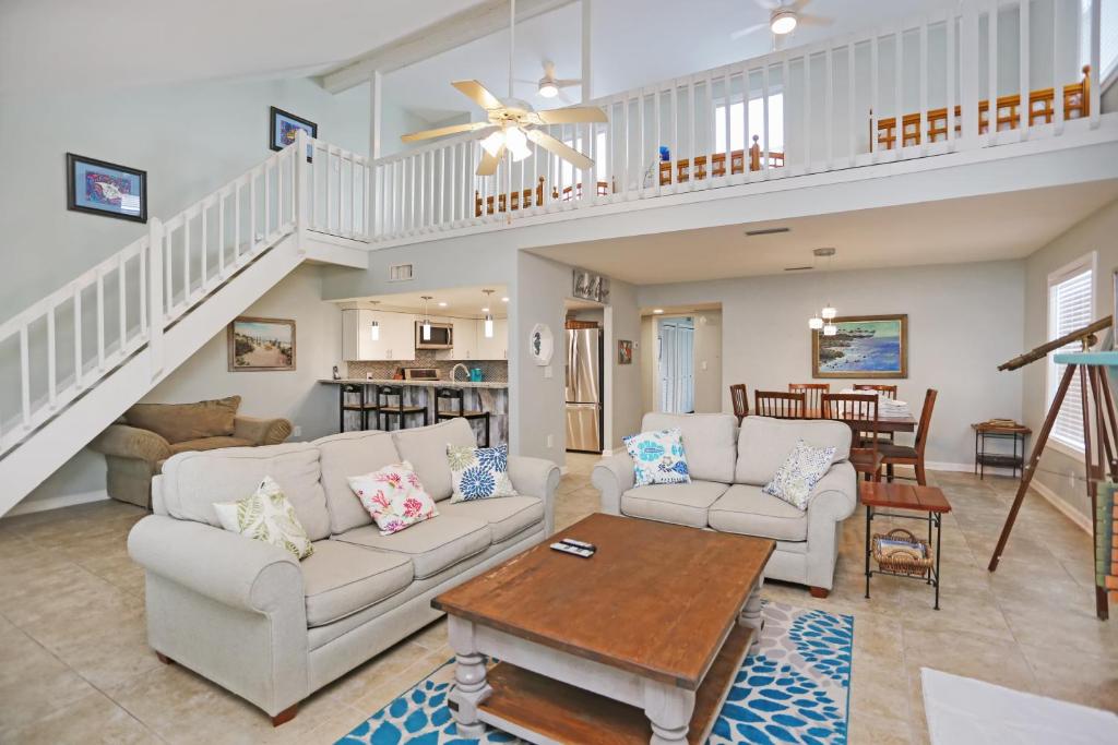 a living room with two couches and a table at Sharkey's by Pristine Properties Vacation Rentals in Cape San Blas