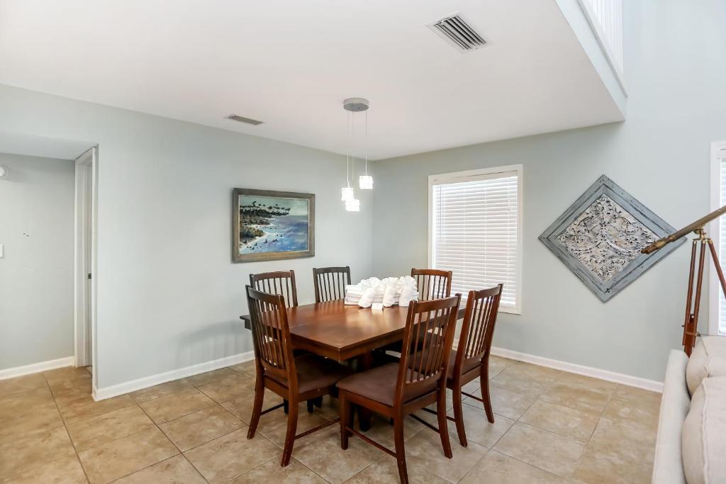 a dining room with a wooden table and chairs at Sharkey's by Pristine Properties Vacation Rentals in Cape San Blas