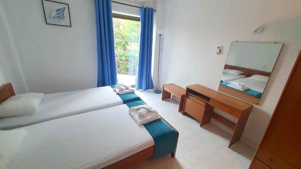 Postel nebo postele na pokoji v ubytování Hotel Pashos