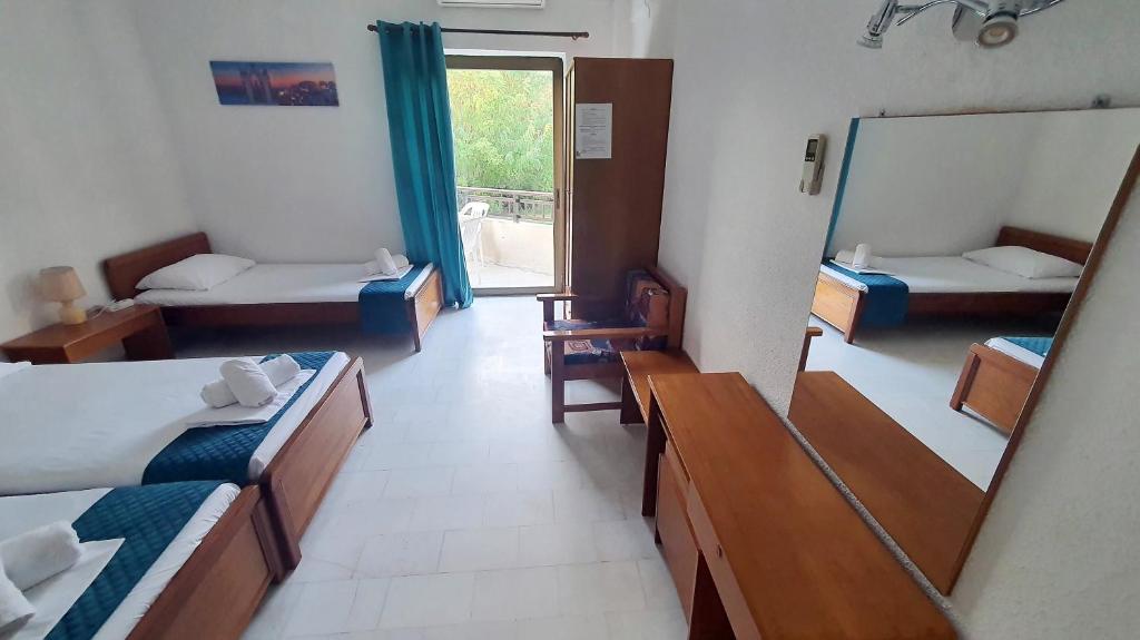 Postel nebo postele na pokoji v ubytování Hotel Pashos