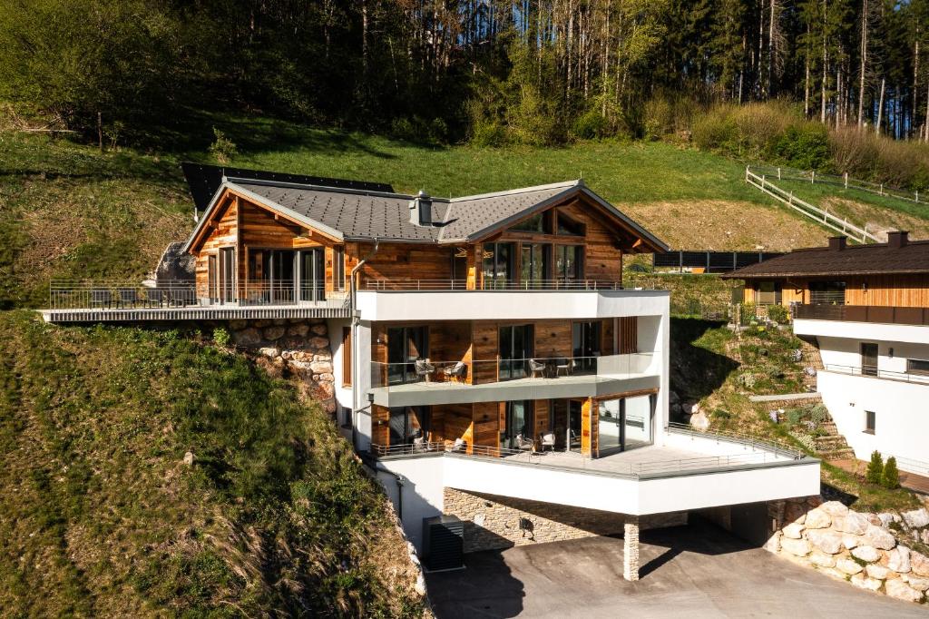 an aerial view of a house on a hill at DasKöniglich Luxury Alpin Chalet - Mühlbach am Hochkönig in Mühlbach am Hochkönig