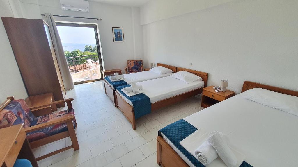 Postel nebo postele na pokoji v ubytování Hotel Pashos