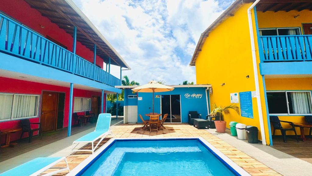 a swimming pool in front of a building at Be Happy Hotel in San Andrés