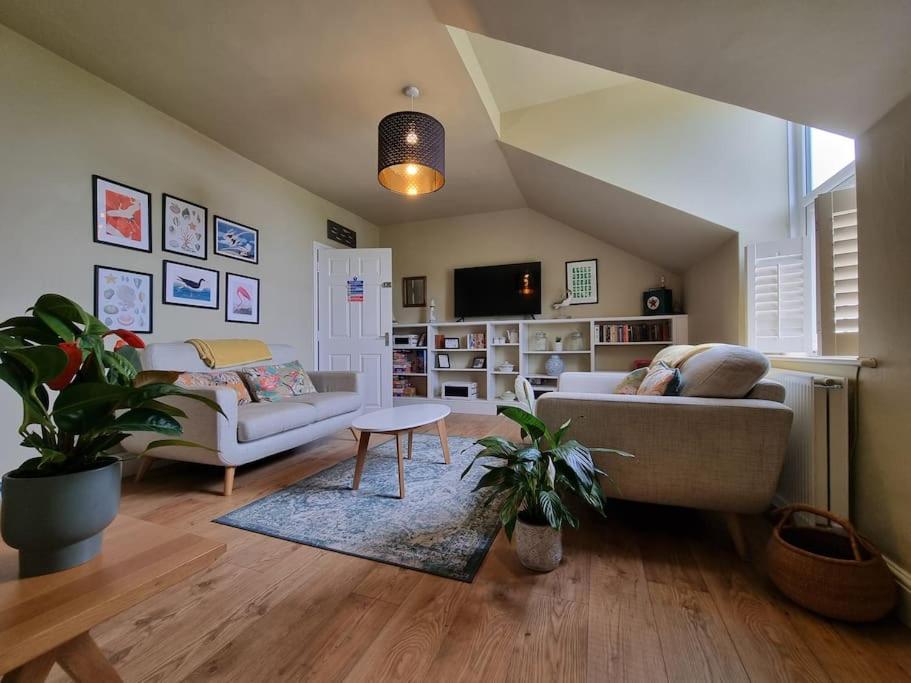 a living room with a couch and a table at Contemporary apartment in Cromer in Cromer