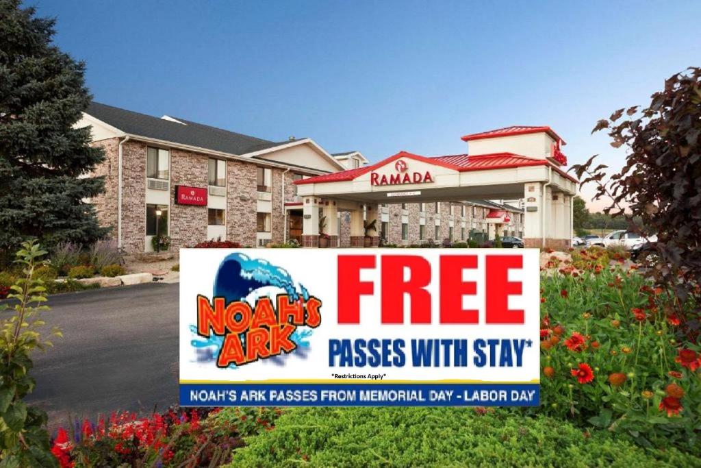 a sign in front of a hotel with a free parking sign at Ramada by Wyndham Wisconsin Dells in Wisconsin Dells