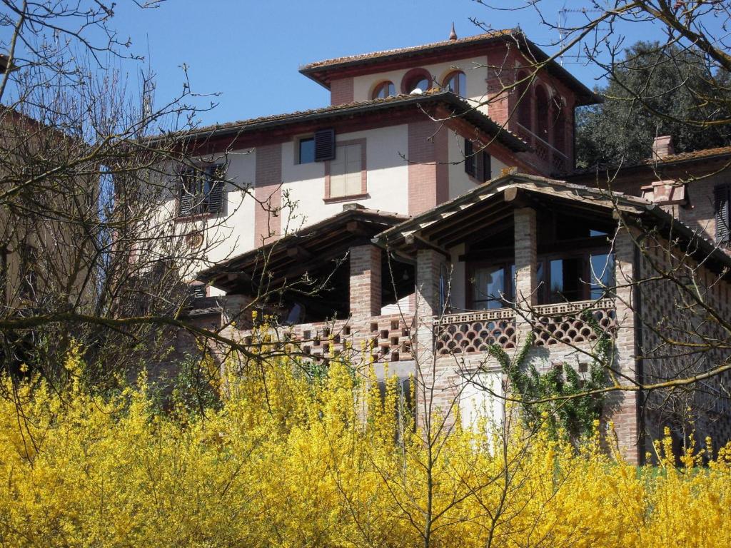 a building with a clock tower on top of it at Villa Caprera in Siena