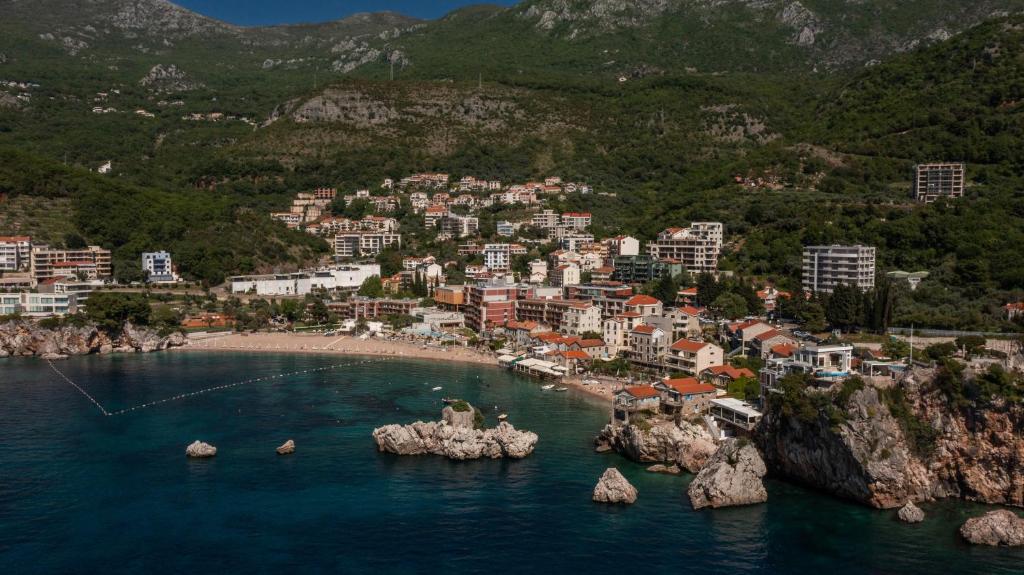 an aerial view of a town on the water with buildings at Apartments Raymond in Sveti Stefan