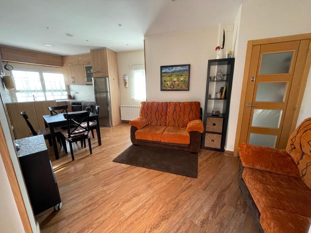 a living room with a couch and a table at Mi Casita de Gredos in Hoyocasero