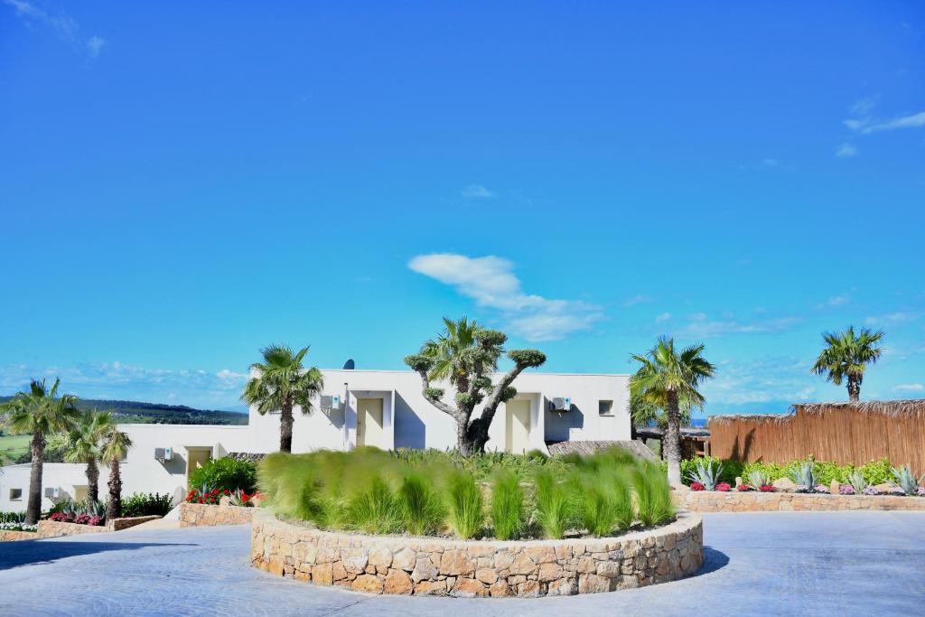 a house with palm trees in the middle of a street at SANIMAR By Mono Alex in Kassandra