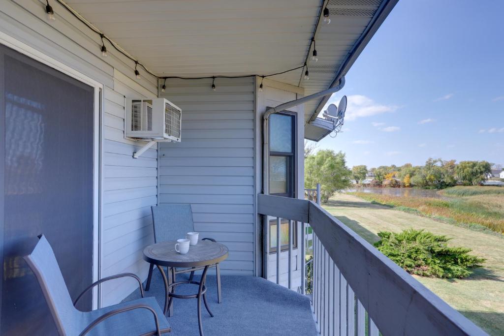 a patio with a table and chairs on a balcony at Pet-Friendly Oak Harbor Condo Walk to Lake! in Sand Beach