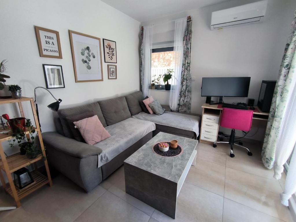a living room with a couch and a table at Apartman Emily2 Dramalj in Dramalj