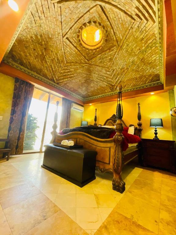 a bedroom with a large bed with a large ceiling at Beautiful house in Rocky Point in Puerto Peñasco
