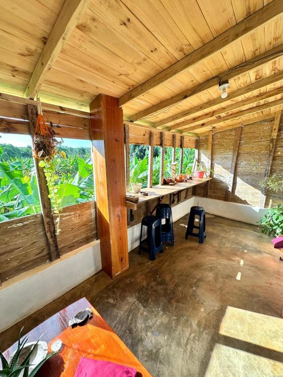 a large room with a table and some windows at Hostel La Ballena Backpacker in Las Galeras