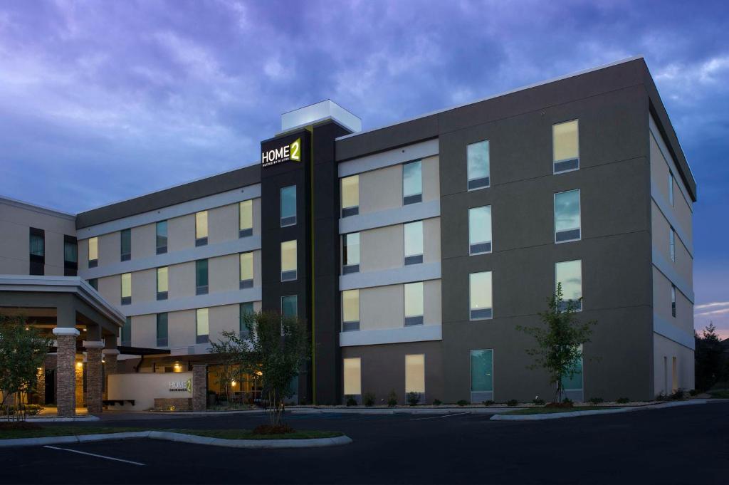 a large building with a hotel sign on it at Home2 Suites by Hilton Hattiesburg in Hattiesburg