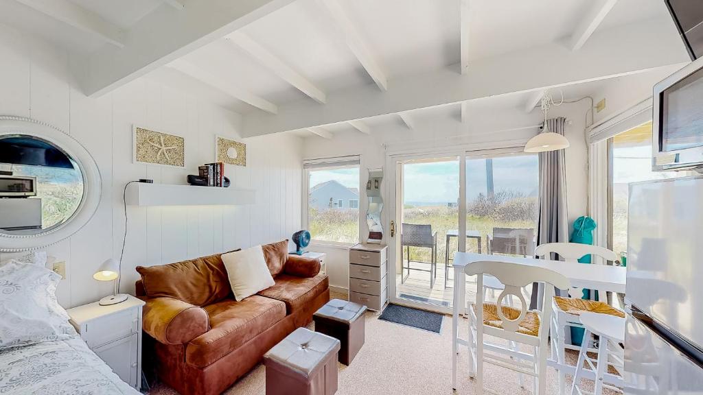 a living room with a couch and a table at Ocean Breeze Retreat in North Truro