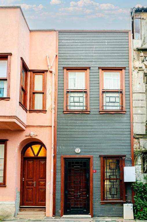 a building with brown doors and windows on a street at The Wall Private Mansion Kumkapı in Istanbul