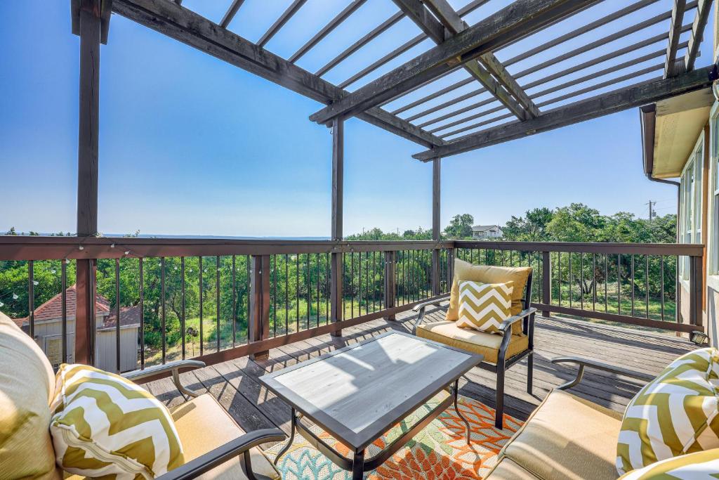 a patio with chairs and a table on a deck at Family-Friendly Fischer Home with Private Hot Tub! in Fischer