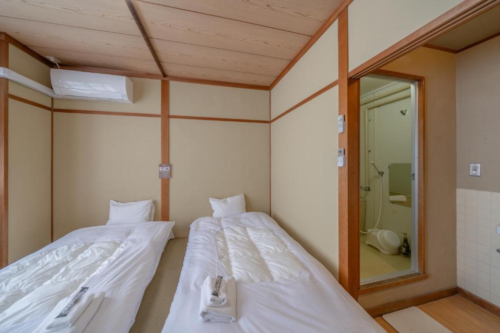 Postel nebo postele na pokoji v ubytování KOMOREBI HOSTEL-your cozy place-