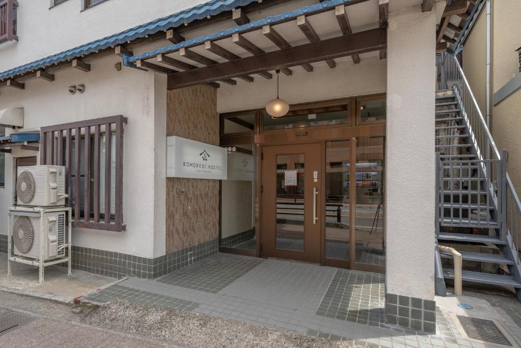 - l'entrée d'un bâtiment avec une porte et des escaliers dans l'établissement KOMOREBI HOSTEL-your cozy place-, à Takayama