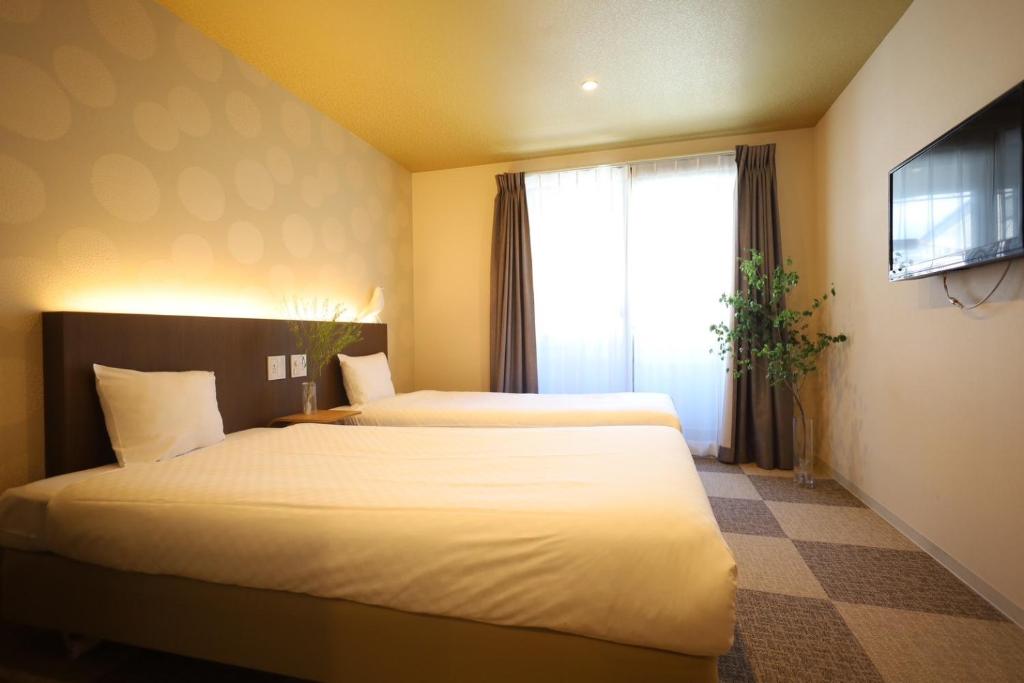 Postel nebo postele na pokoji v ubytování HOTEL THE POINT Kiyomizu Gojo