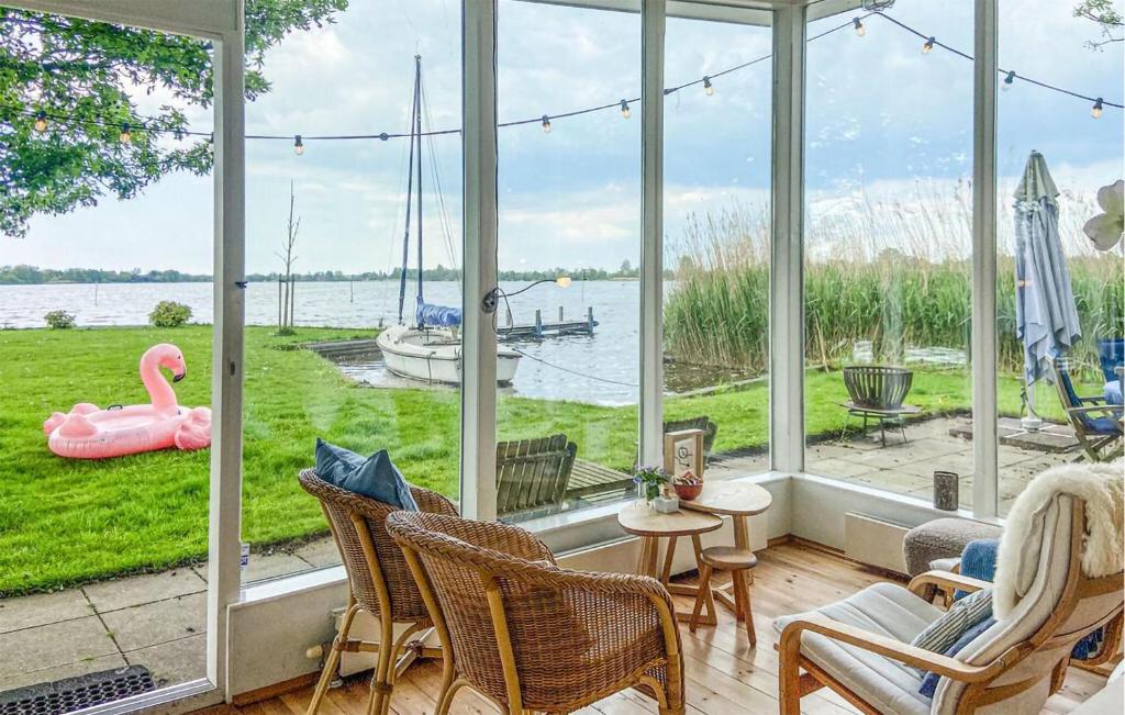 a screened in porch with a view of the water at Lakehouse Reeuwijk in Reeuwijk