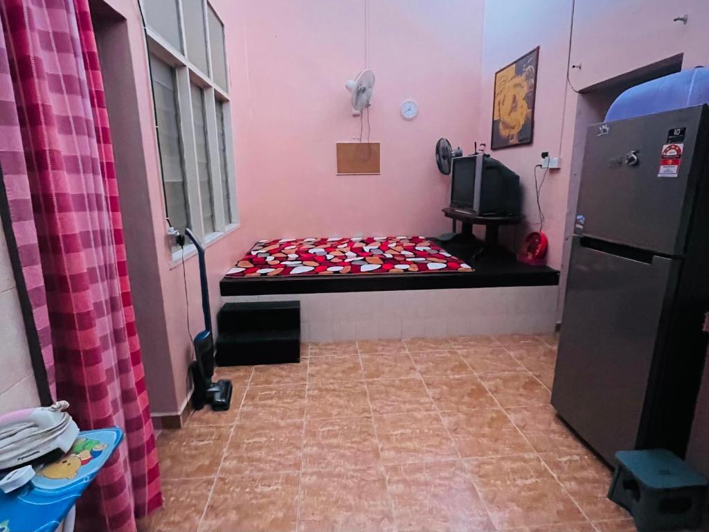 Postel nebo postele na pokoji v ubytování Kota Bharu Homestay