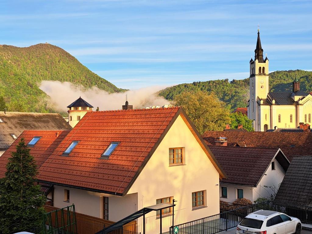 a group of houses with a castle in the background at Boutique Hotel Vila Loka in Škofja Loka