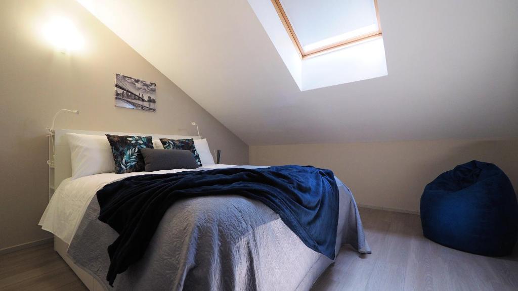 a bedroom with a bed with a laptop on it at Blu Note Apartment in Turin