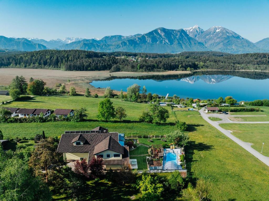 an aerial view of a house next to a lake at Ferienwohnungen Martha in Obersammelsdorf