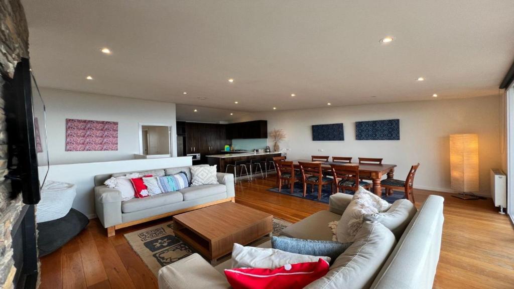 a living room with two couches and a dining room at K2 - Thirteen in Mount Buller
