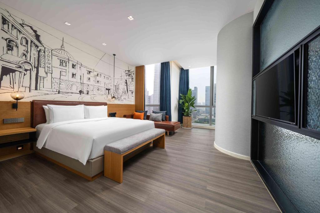 Postel nebo postele na pokoji v ubytování UrCove by Hyatt Guangzhou Canton Tower Exhibition Center-Registration Counter and Free Shuttle Bus Available during Canton Fair Period