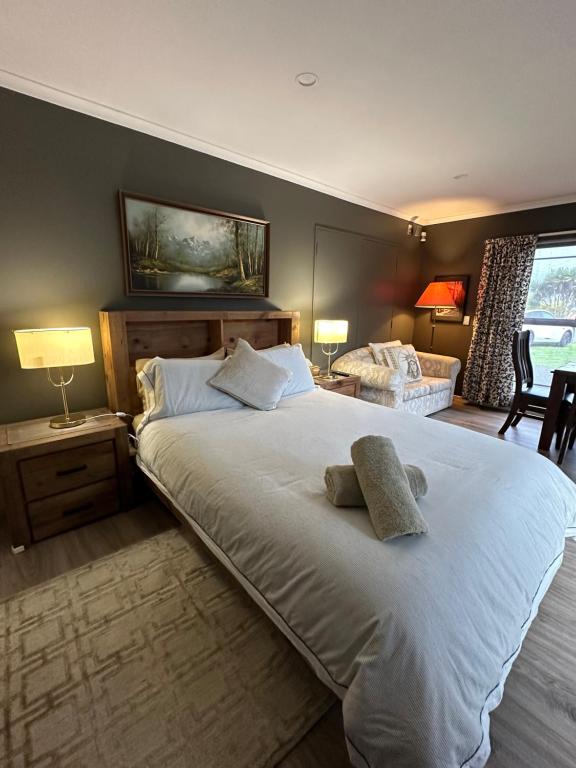 a bedroom with a large bed with two towels on it at Lakeview Holiday Hideaway in Taupo