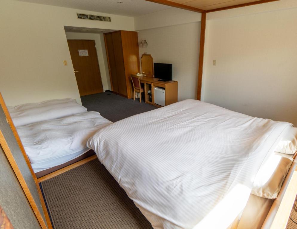Postel nebo postele na pokoji v ubytování Hakuba Panorama Hotel