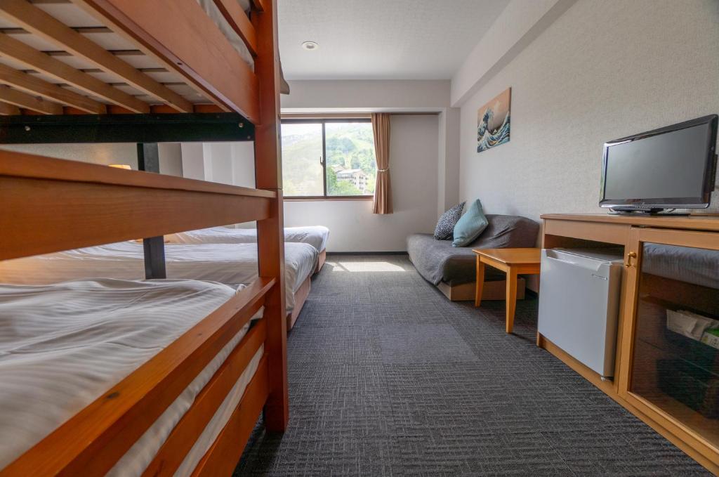 Postel nebo postele na pokoji v ubytování Hakuba Panorama Hotel