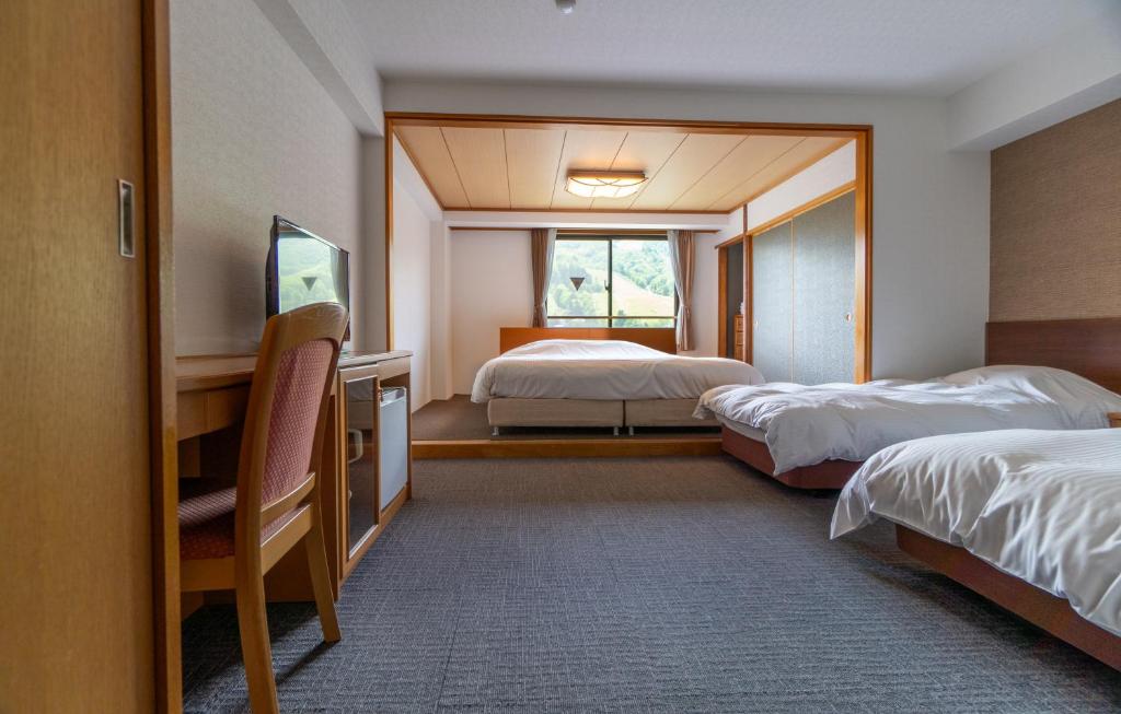 Postel nebo postele na pokoji v ubytování Hakuba Panorama Hotel