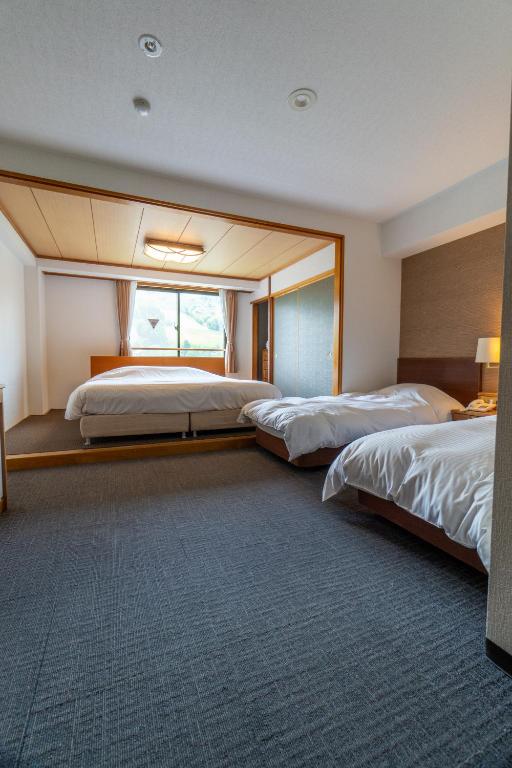 Postel nebo postele na pokoji v ubytování Hakuba Panorama Hotel