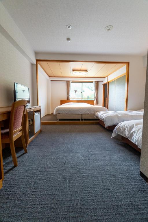 Postel nebo postele na pokoji v ubytování Hakuba Panorama Hotel