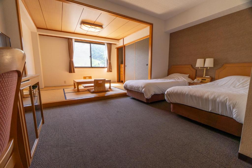 Postel nebo postele na pokoji v ubytování Hakuba Panorama Hotel