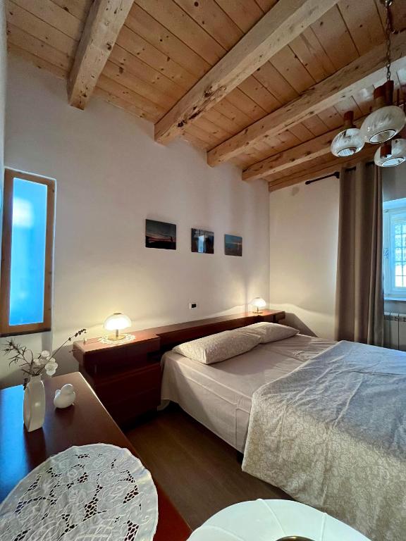 a bedroom with a bed and a table with two lamps at Pucino apartments in Trieste