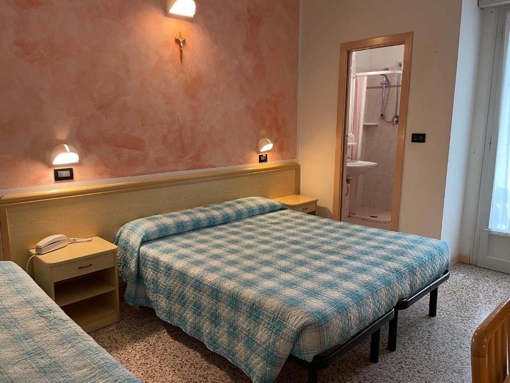 Postel nebo postele na pokoji v ubytování Piccolo Hotel
