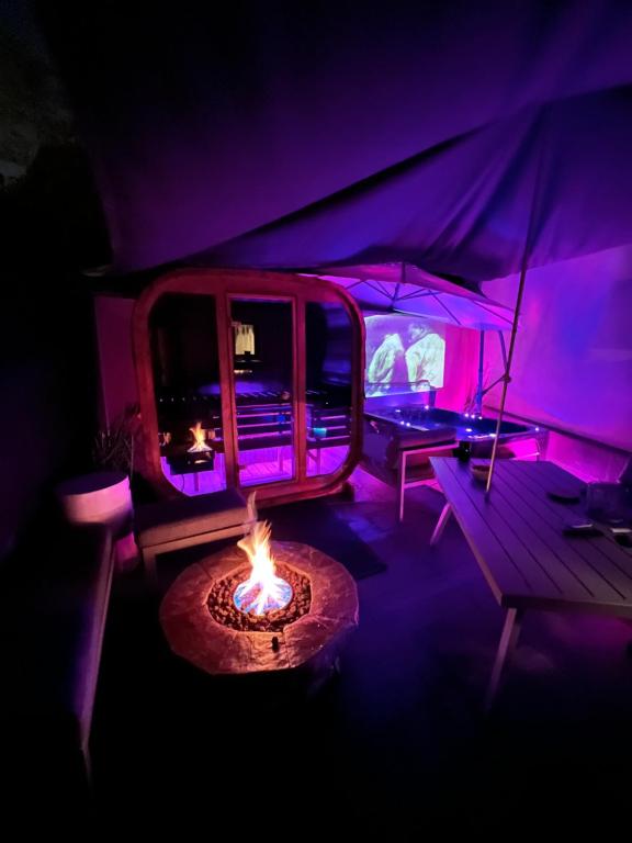 a room with a tent with a fire in it at Maison spa sauna in Morangis