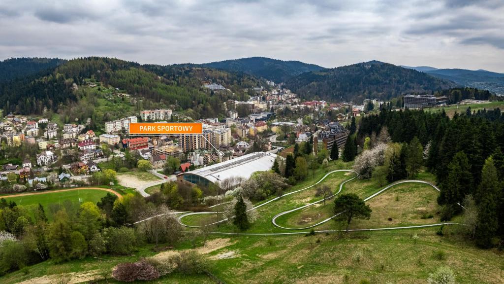 an aerial view of a town in the mountains at Park Sportowy, Sun & Snow in Krynica Zdrój