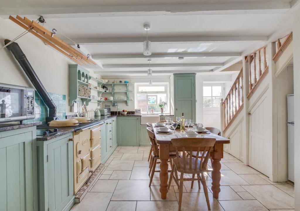 a kitchen with a table and chairs in it at Stargazy in Mousehole