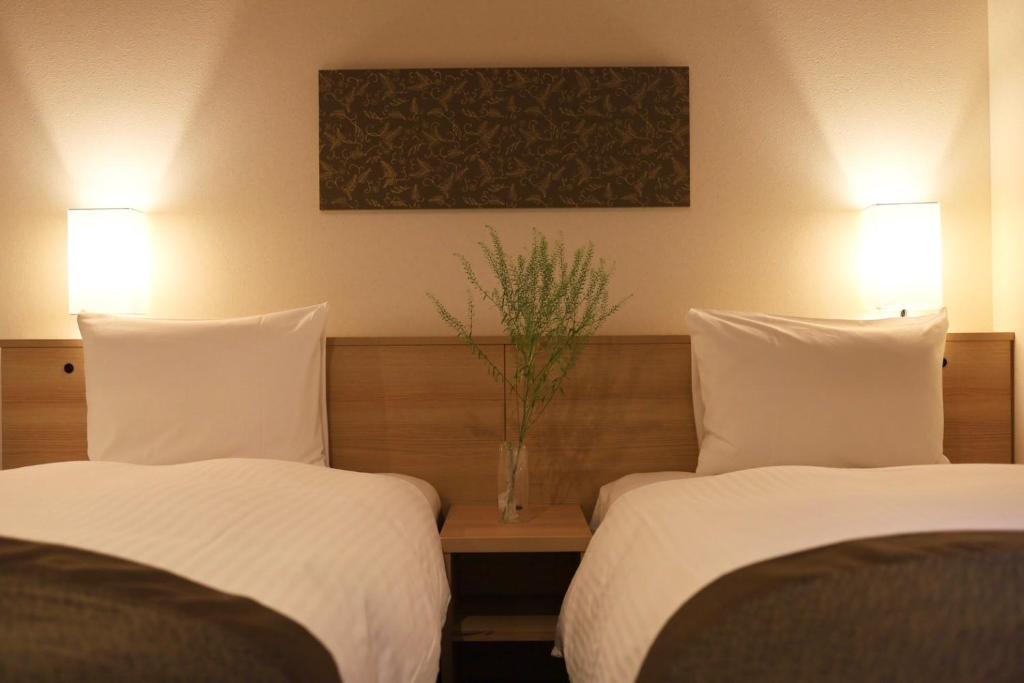 Postel nebo postele na pokoji v ubytování Xcellent Hotel